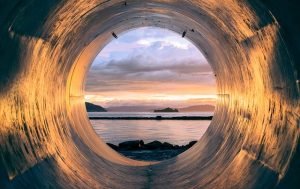 Crawl space, silver tunnel overlooking water