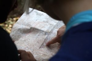 2 people looking at map, locating