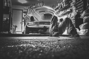 garage, man under car. Place mouse trap here